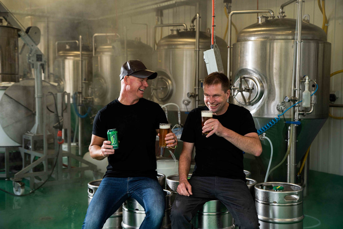 Brewers with beers in the brewhouse at Grunthal Brew, Verdun